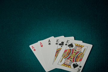 view of a game table with green carpet where are the cards with full of aces and kings