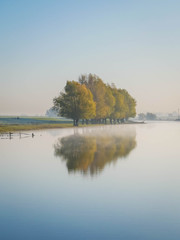  Group of colorful trees with reflection on mirror-like water
