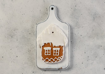 Glazed gingerbread house on a wooden board