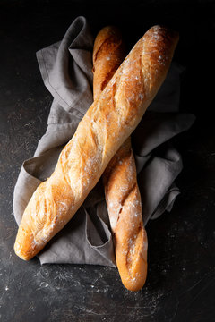 Fresh Hot Baguette On Dark Background.