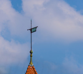 old metal wind compass on roof with year sign 1909