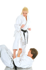 Obraz premium Cute blonde girl and a young cheeky guy karate