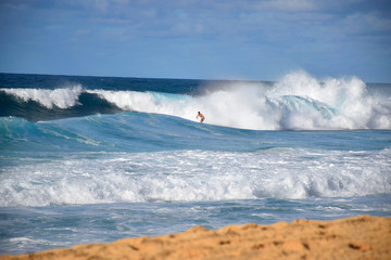 10/10: Hawaiian Surfer Taking on a Massive Rainbow Wave at the Banzai Pipeline, Oahu, Hawaii