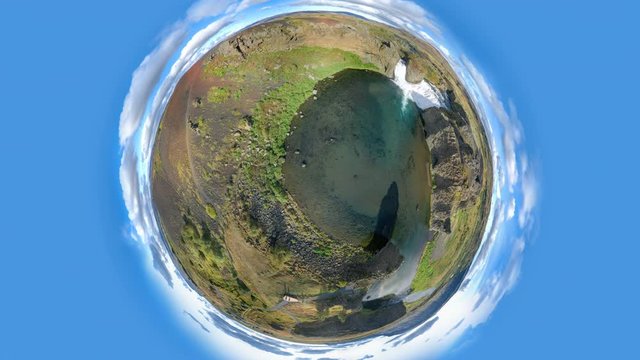 Epic aerial drone view flying over landscape of Hjalparfoss waterfall and lagoon on a sunny day. Little planet panorama