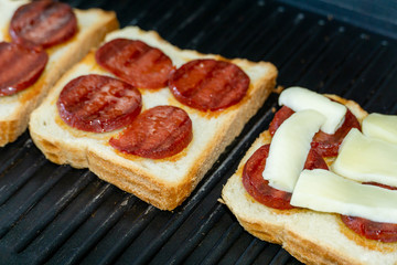 sausage and cheese toast. toaster bread in toaster