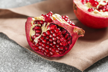 Ripe juicy pomegranate on grey background