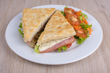 Craft sandwich with oregano, ham, cheese and salad