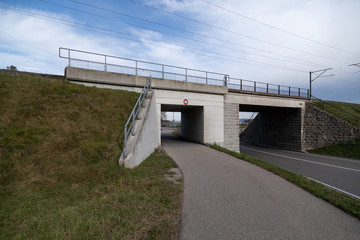 white concrete railway bridge with car and pedestrian underpass maximum high 2.90 meters wide angle...