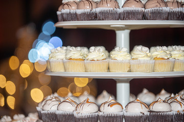 Assorted cupcakes on white cupcake tower