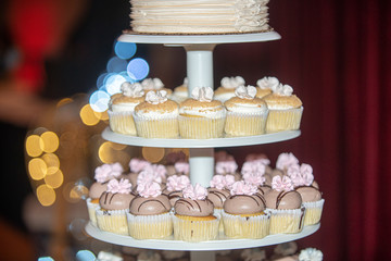 Assorted cupcakes on white cupcake tower