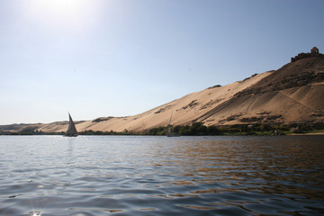 Fototapeta na wymiar boat on the river Nile with sand dunes