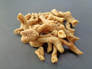 Close up view of kripik keripik usus ayam or gut chicken fried snack fritters crackers. traditional menu from Indonesia. Clean bowels inside, covered with flour, then frying on hot oil
