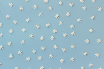 White pretty sugar snowflakes on blue background