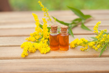 goldenrod essential oil in  beautiful bottle on table