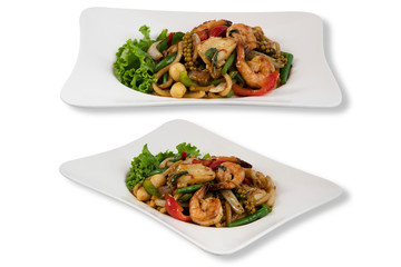 Isolated on White Background of Spicy Udon Noodle with Seafood and Basil leaf. Asian Food. Clipping Path Included