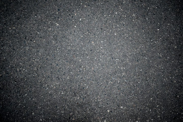 Asphalt texture closeup shot illuminated by the setting sun
