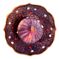 Fresh fig in a patterned plate isolated on white background. Top view.