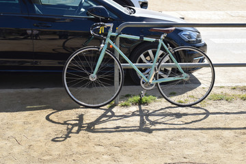 Fototapeta na wymiar Bicycle Locked to Steel Fence in Sunny Park 3464-039