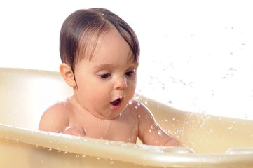 Happy one year old girl play with water