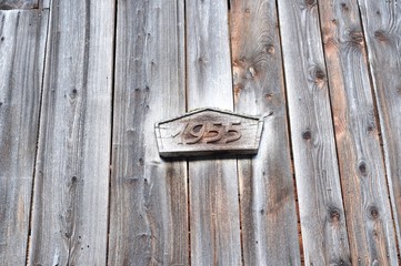 Number and the year 1955 carved in wood