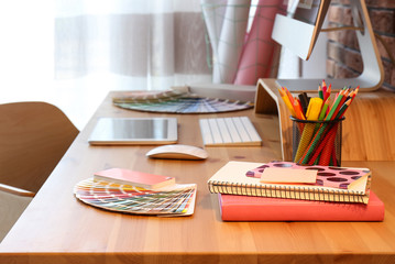 Office supplies and computer on wooden table. Designer's workplace