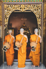 Newly ordained Buddhist monk pray with priest procession.