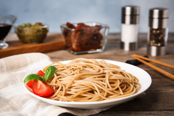 Tasty buckwheat noodles served on wooden table