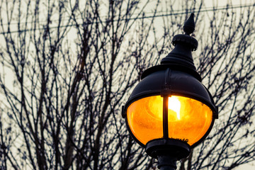 old street lamp on background of blue sky