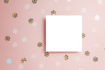 White gretting card with golden stars confetti on pink background, minimal style