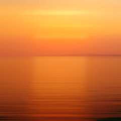 Abstract orange background motion blur sunset on the sea