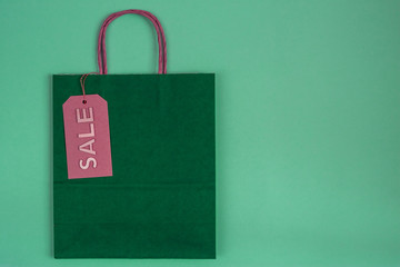 green paper craft bag with sale tag