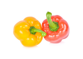 whole fresh red and yellow bell pepper with stem on white background