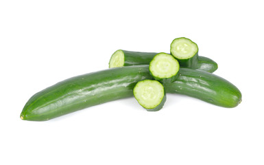 uncooked whole and sliced fresh Japanese cucumbers on white background