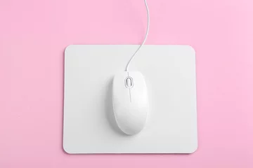 Foto op Canvas Modern wired mouse and white pad on pink background, top view © New Africa