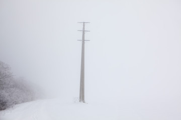 electric pole on a snowy hill