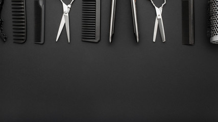 Flat lay composition with Hairdresser tools: scissors, combs, hair iron on black background. Frame. Hairdresser service. Beauty salon service. Hairdresser Set. Long banner background with copy space