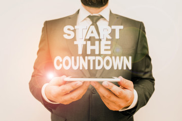 Text sign showing Start The Countdown. Business photo text Sequence of Backward Counting to Set the Timer Male human wear formal work suit hold smart hi tech smartphone use hands