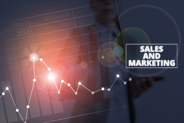 Writing note showing Sales And Marketing. Business concept for Promotion Selling Distribution of...
