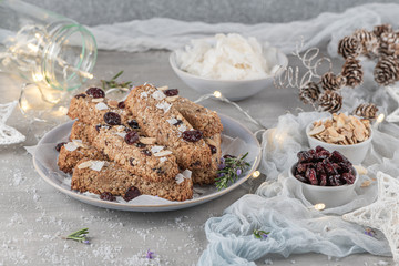 Granola bar. Healthy snack. Cereal granola bar with nuts, fruit, coconut and cranberries on a christmas table