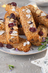 Granola bar. Healthy snack. Cereal granola bar with nuts, fruit, coconut and cranberries on a christmas table