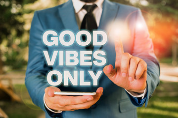Conceptual hand writing showing Good Vibes Only. Concept meaning Just positive emotions feelings No negative energies Businessman with pointing finger in front of him