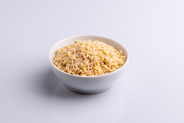 Orzo pasta, isolated on white background. Italian orzo pasta shaped like grains of rice, copy space, soft light