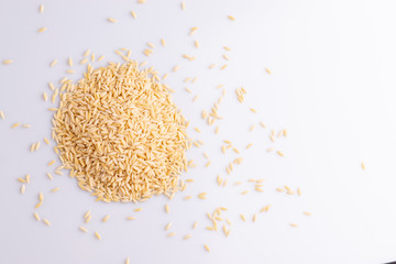 Orzo pasta, isolated on white background. Italian orzo pasta shaped like grains of rice, copy space, soft light