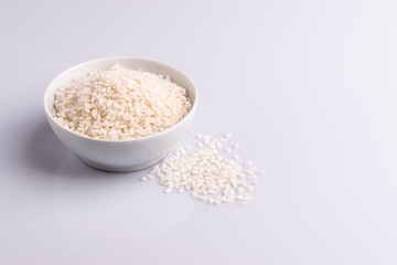 Italian Risotto rice on white background. Copy Space. Soft light. Latin term 