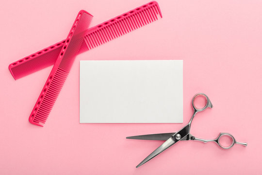Hairdresser. Scissors, combs and other hairdresser accessories and strand of blonde hair on pink background. Mockup for gift card. Flat lay with space for text.Hairdresser service.Beauty salon service