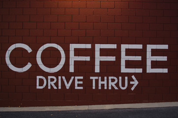 The coffee is wrote on the wall in the downtown area in the morning. 