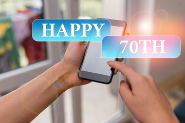 Text sign showing Happy 70Th. Business photo text a joyful occasion for special event to mark the 70th year woman using smartphone office supplies technological devices inside home