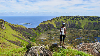 Young woman on the edge of the Ra-nu Kao volcano on Easter Island. Chile