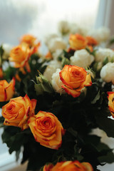 multi-colored lush bouquet of roses from orange and white roses