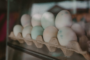 Pink Chicken Eggs on the counter behind the glass in Asia